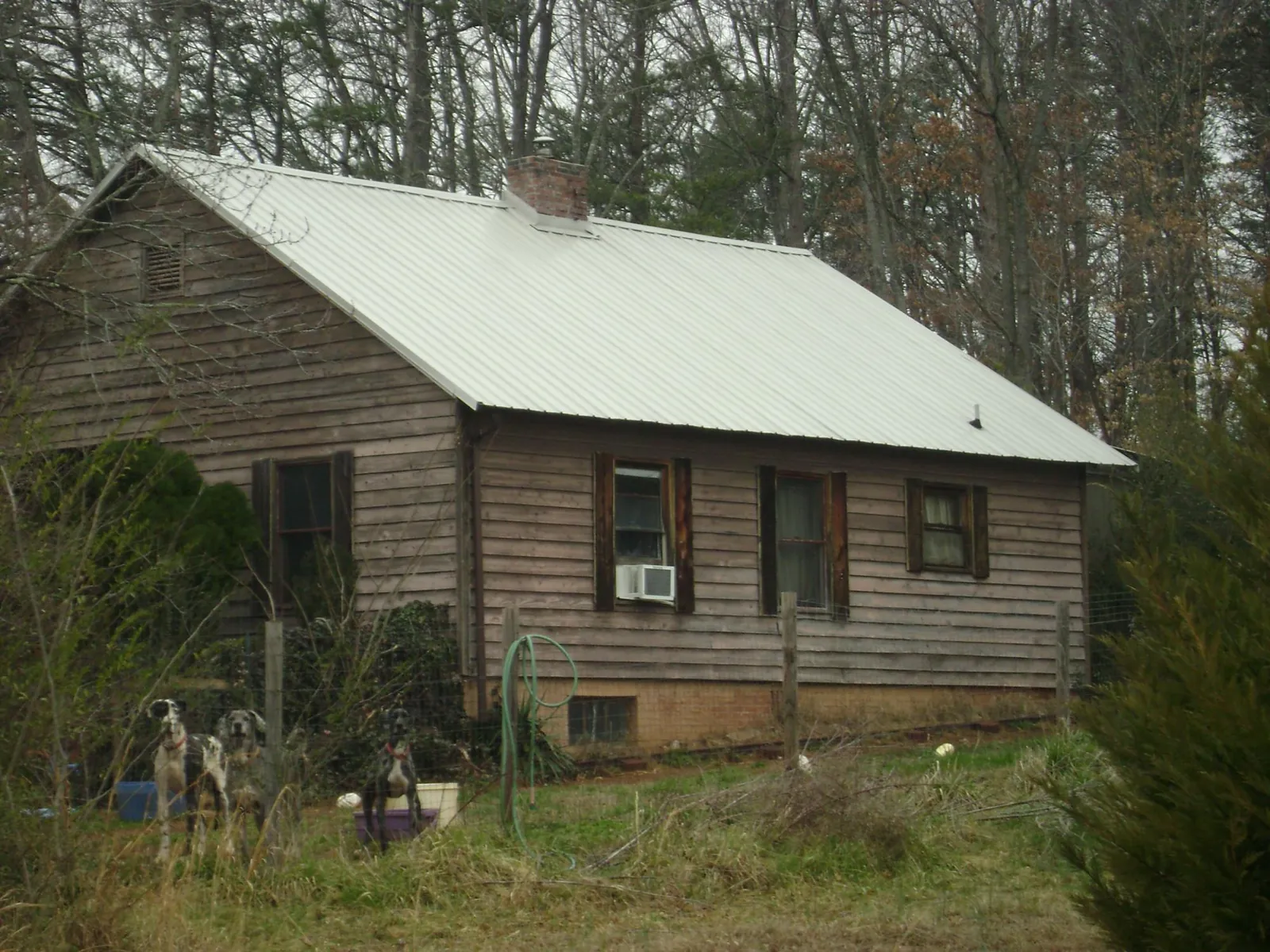 White metal roof on an old wood sided farmhouse, from a Asphalt Shingle Roof Repair job in Radford